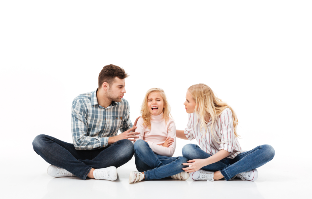 young parents sitting on ground with child